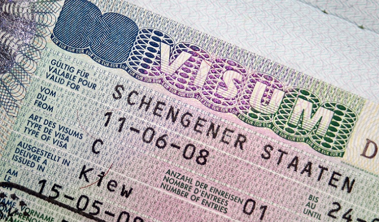 Close-up page of passport with Schengen visa